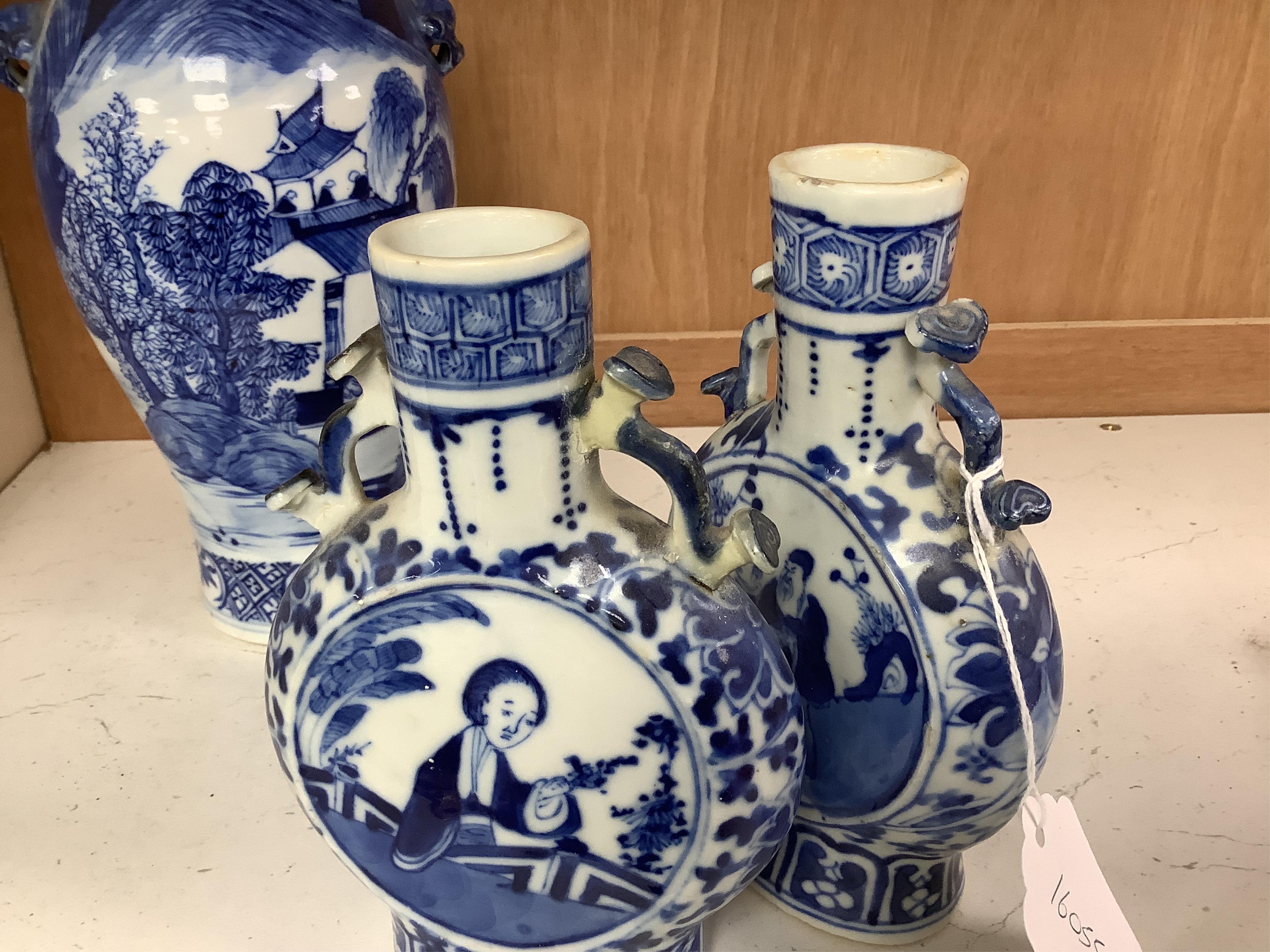 Late 19th century Chinese vases; pair of small Chinese blue and white moon flasks and a larger Chinese blue and white landscape vase, larger vase 22cm high. Condition - one moon flask handle restored, other items fair